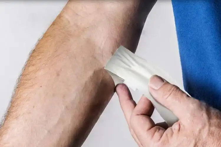 How does cotton adhesive tape compare to kinesiology tape for ankle support?